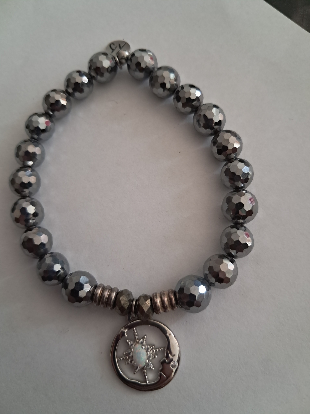 T. Jazelle Faceted Hematite Bracelet - Celestial Sun & Moon Charm